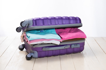 Travel and vacations concept. Open traveler's bag with clothing, accessories, credit card, tickets and passport.の写真素材