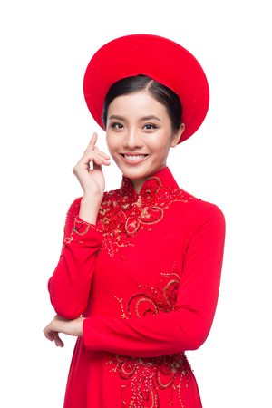 Charming Vietnamese Bride in Red Ao Dai Traditional Dress with hat.の写真素材