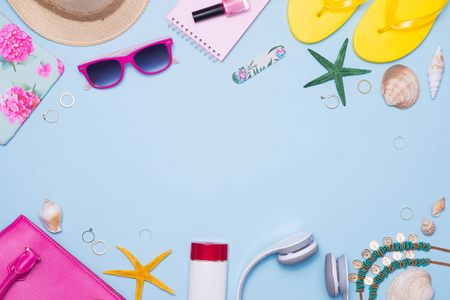 Summer concept. Pink handbag with accessories on light blue backgroundの写真素材