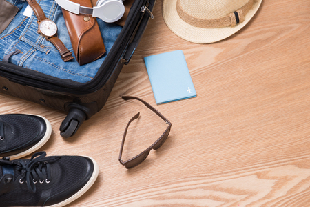 Travel and vacations concept. Open traveler's bag with clothing, accessories, credit card, tickets and passport.の写真素材