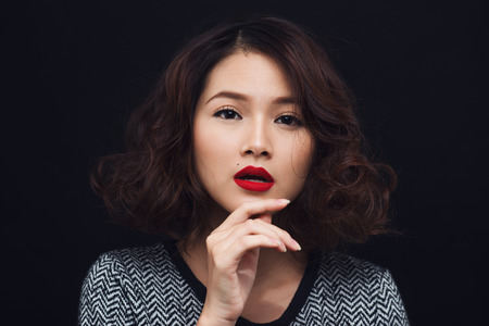 Beauty portrait of asian woman. Magnificent model posing on black background.の写真素材