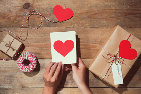 Valentine's decorated gift box over wooden background. View from aboveの写真素材