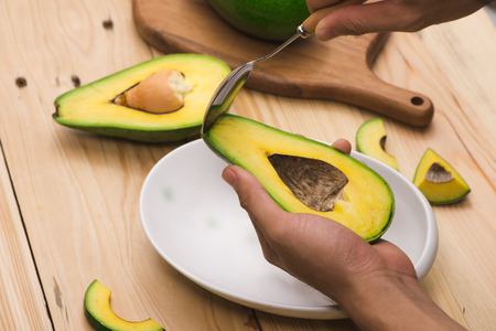 Healthy food concept. Eating fresh organic avocadoの写真素材