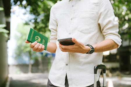 Man hands holding Vietnamese Passport. Ready for traveling.の写真素材