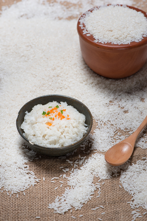 close up of rice in wooden in bowl on wooden tableの写真素材
