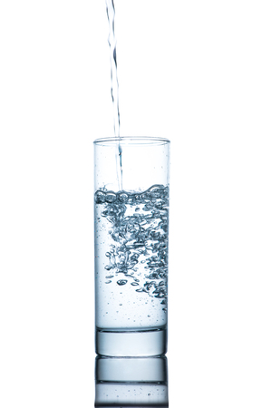 Drinking water is poured into a glassの写真素材