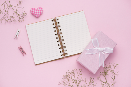 Gift box tied with pink ribbon and white flowers for mothers dayの写真素材