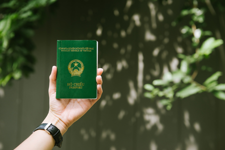 Man hands holding Vietnamese Passport. Ready for traveling.の写真素材