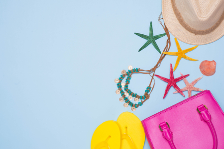 Summer concept. Pink handbag with accessories on light blue backgroundの写真素材