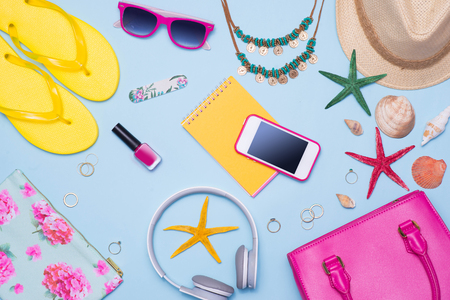 Summer concept. Pink handbag with accessories on light blue backgroundの写真素材