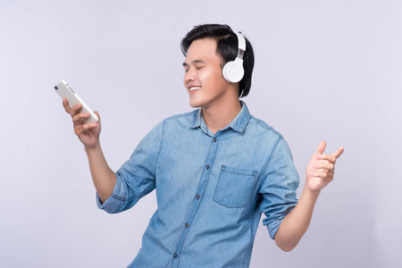Smart casual asian man with headphone in studio backgroundの写真素材