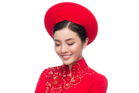 Charming Vietnamese Bride in Red Ao Dai Traditional Dress with hat.の写真素材