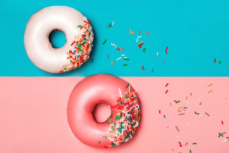 Donuts with icing on colorblock background. Sweet donuts.の写真素材