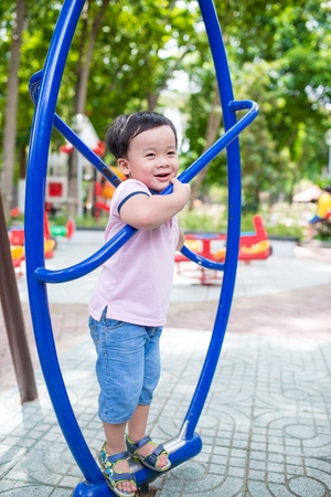 Happy little boy having fun at playground in summer.の写真素材