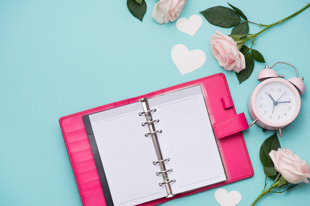 Pink roses with notebook.の写真素材
