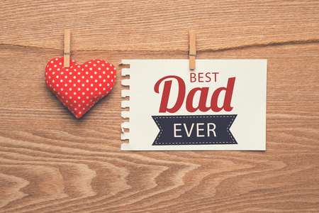 Happy fathers day sign with heart on wooden background.の写真素材
