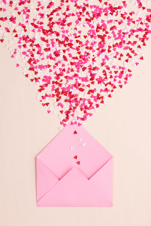 Sweets sugar candy hearts on envelope over green backgroundの写真素材