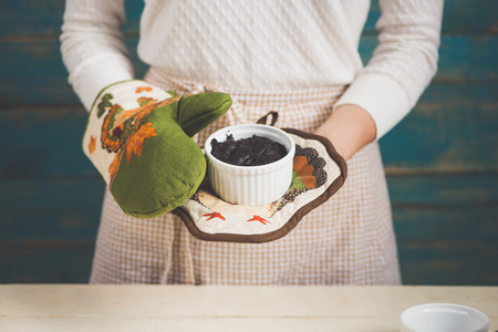 Chocolate homemade dark muffin in mom hands.の写真素材