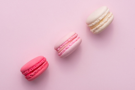 Tasty pink cake macaron or macaroon on pink background from aboveの写真素材