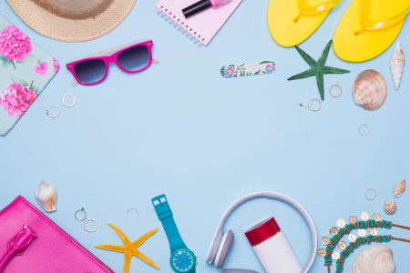 Summer concept. Pink handbag with accessories on light blue backgroundの写真素材