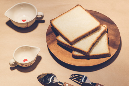 Close-up of slice of toast bread on wood tableの写真素材