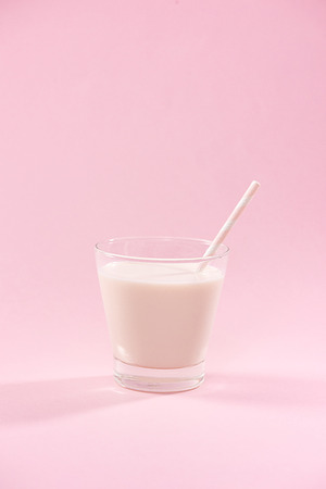 Dairy products. A glass of milk on a pink background.の写真素材