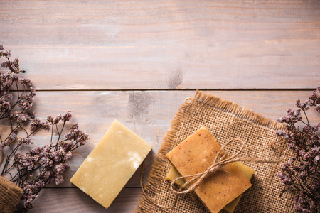 Natural soap with dried flowers on wooden background.の写真素材