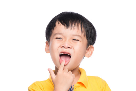 Lost milk tooth asian boy, Close up view.の写真素材