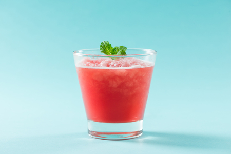 Glass of healthy watermelon juice in summertime on blue background.の写真素材
