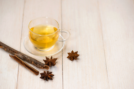 Cup of black tea with spices on white wooden background.の写真素材