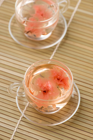 Cherry blossom (sakura) Japanese Herb tea on table.の写真素材