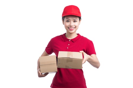 Portrait of delivery woman service happily delivering package to costumerの写真素材