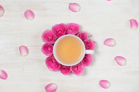 Tea time. Light background with flowers and cup of tea.の写真素材