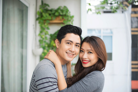 Couple in love sharing genuine emotions and happiness, hugging on the balconyの写真素材