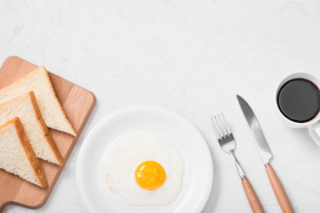 Traditional breakfast with fried eggs on a plateの写真素材