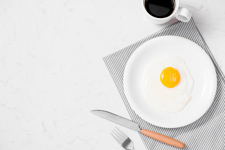 Top view of traditional healthy easy quick breakfast meal made of fried eggs served on a plate.の写真素材