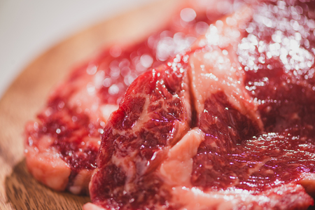 Raw beef meat on a plate on dark table. Selective focusの写真素材
