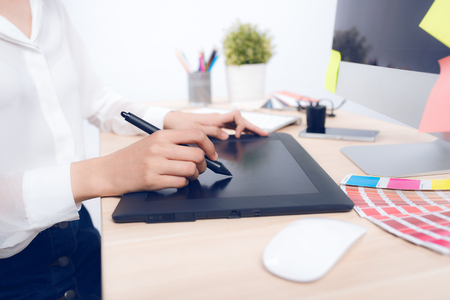 High angle view of a photo editor working at desk in creative officeの写真素材
