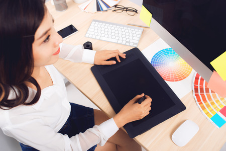High angle view of a photo editor working at desk in creative officeの写真素材