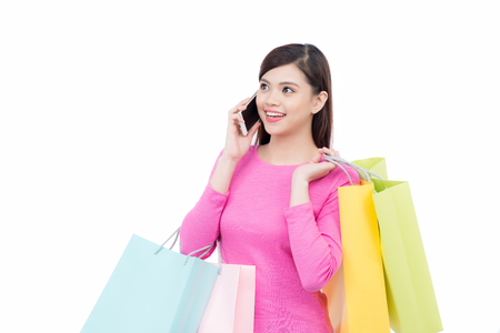 Shopping asian woman with mobile phone on white background.の写真素材