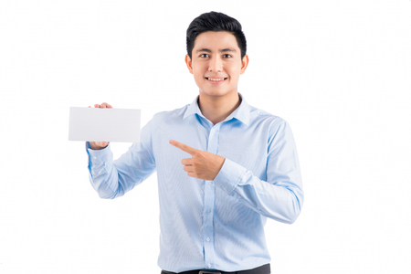 Young businessman holding a blank card. Concept - a demonstration of achievements in business, graphic ads. Isolated on white.の写真素材
