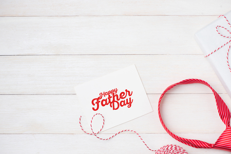 Happy Father's Day with striped tie on wooden background. Greetings and gift boxの写真素材