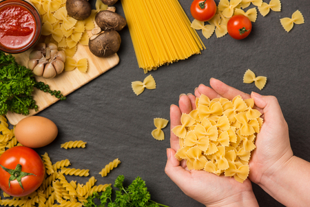 Italian food concept. Pasta ingredients. Cherry-tomatoes, spaghetti pasta, rosemary and spicesの写真素材