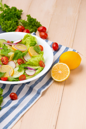 Homemade fresh green vegetable salad on table.の写真素材