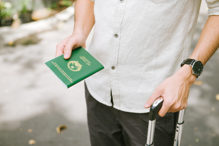Man hands holding Vietnamese Passport. Ready for traveling.の写真素材