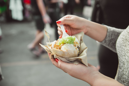 Woman hands holding ice cream on coconutの写真素材