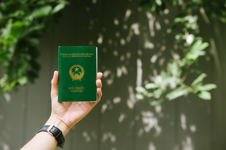 Man hands holding Vietnamese Passport. Ready for traveling.の写真素材