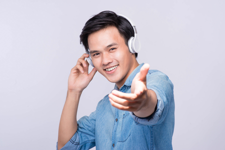 Smart casual asian man with headphone in studio backgroundの写真素材