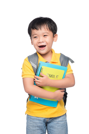Portrait of cute smiling boy with backpack and colorful books, education and back to school conceptの写真素材