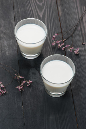Dairy products. Two glasses of milk on a rustic wooden table.の写真素材
